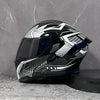 A black and silver DOT-approved modular flip-up motorcycle helmet resting on a dark surface.