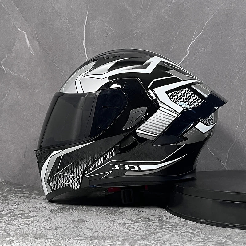 A black and silver DOT-approved modular flip-up motorcycle helmet resting on a dark surface.