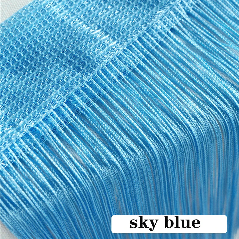 Close-up of sky blue beaded thread curtain fabric showing fine vertical threads.