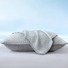 A light gray breathable cooling pillowcase folded and displayed on a white surface.