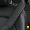 A close-up of a black PU leather embossed seat belt shoulder cushion on a vehicle seat.