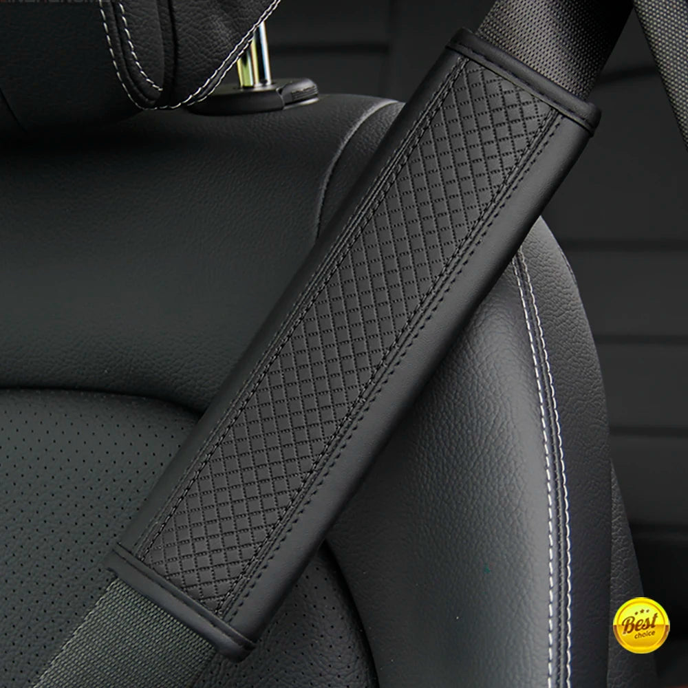 A close-up of a black PU leather embossed seat belt shoulder cushion on a vehicle seat.