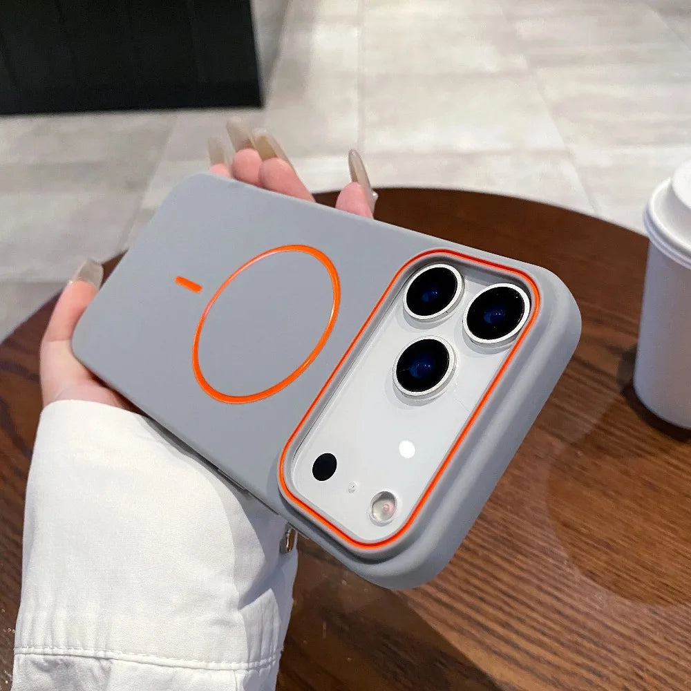 A hand holds a matte gray phone case with MagSafe support and an orange circular design on the back.