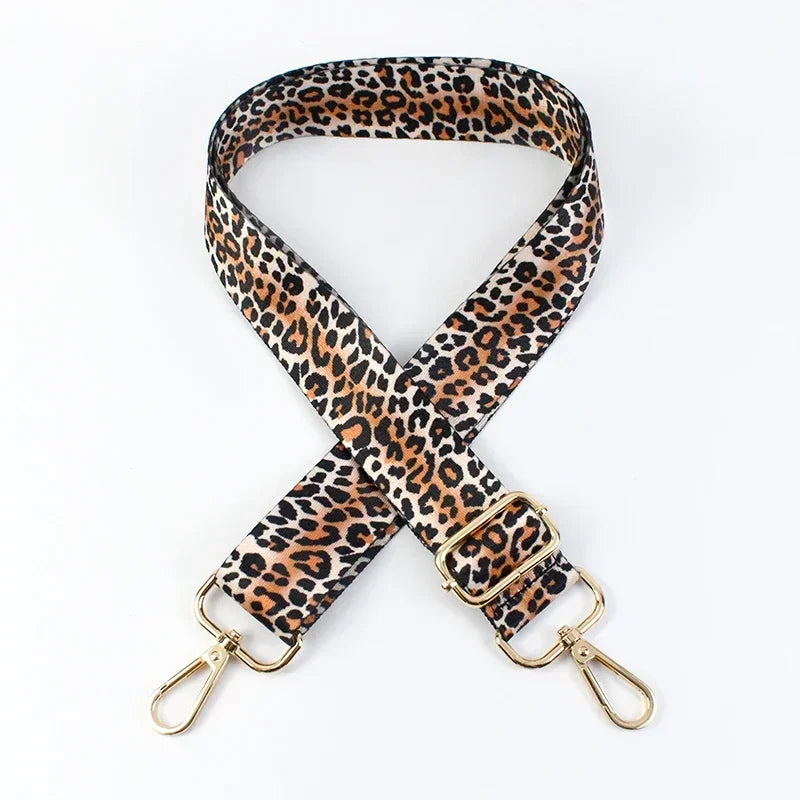 A leopard print wide adjustable crossbody bag strap in brown and black spots.