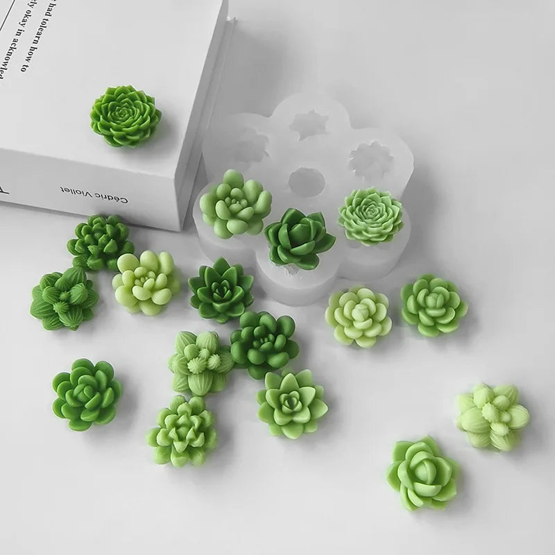 A set of green silicone molds shaped like succulent flowers for DIY crafts displayed on a white surface.