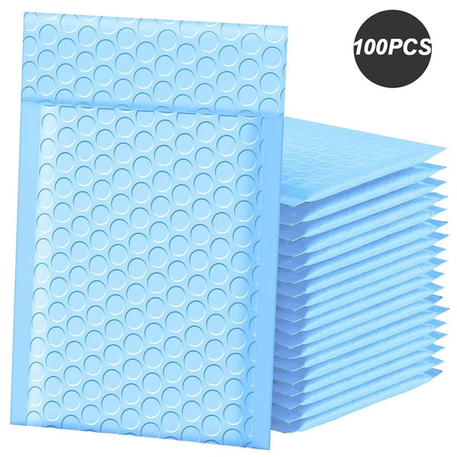 A stack of 100 blue bubble mailers, padded self-seal shipping envelopes.