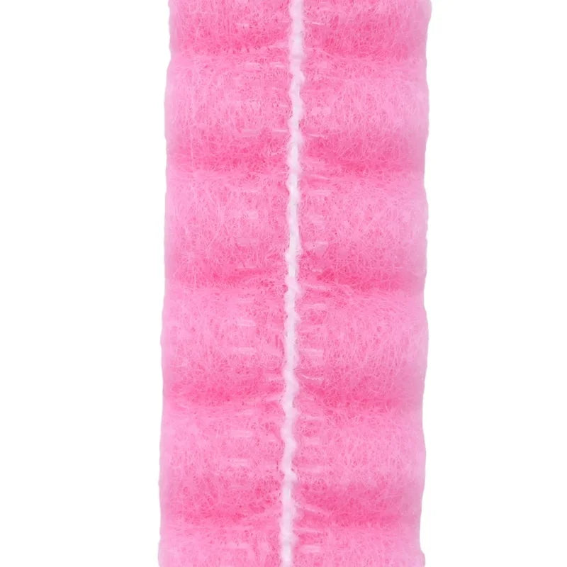 A roll of pink disposable non-woven hair net caps.