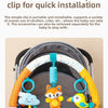 A baby stroller arch toy features colorful hanging plush charms, including a cloud, an fox, and a yellow bird.