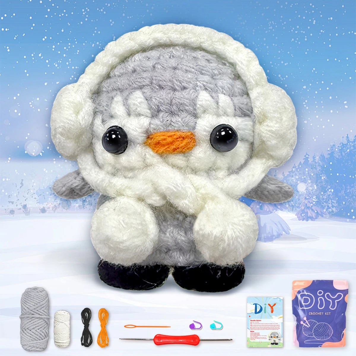 A cute gray and white animal amigurumi plush toy with a knitted hood, along with crochet tools.
