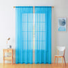 Two panels of sheer blue voile curtains hanging in a window frame.