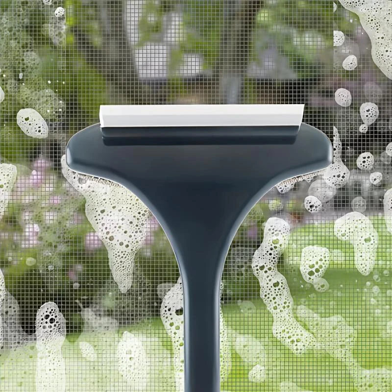 A dark cleaning brush with a white cleaning pad is shown against a background of water droplets and a green outdoor scene.