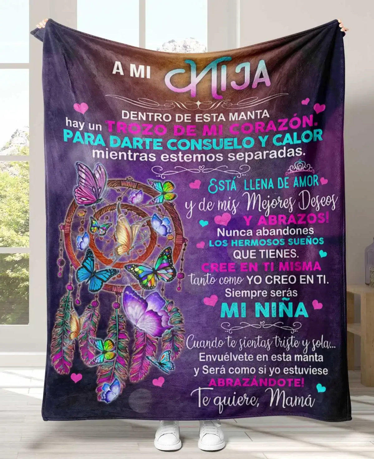 A dark purple flannel throw blanket featuring a design with Spanish text and colorful butterflies