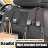 Multi-function car hook with leather straps and metal clasps designed to organize items on a car seat headrest.