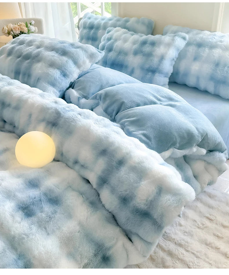 A light blue and white plaid fleece duvet cover with a rabbit design displayed on a bed.