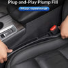 A hand is inserting a red plug-and-play filler strip into a gap in a black car seat to expand storage.