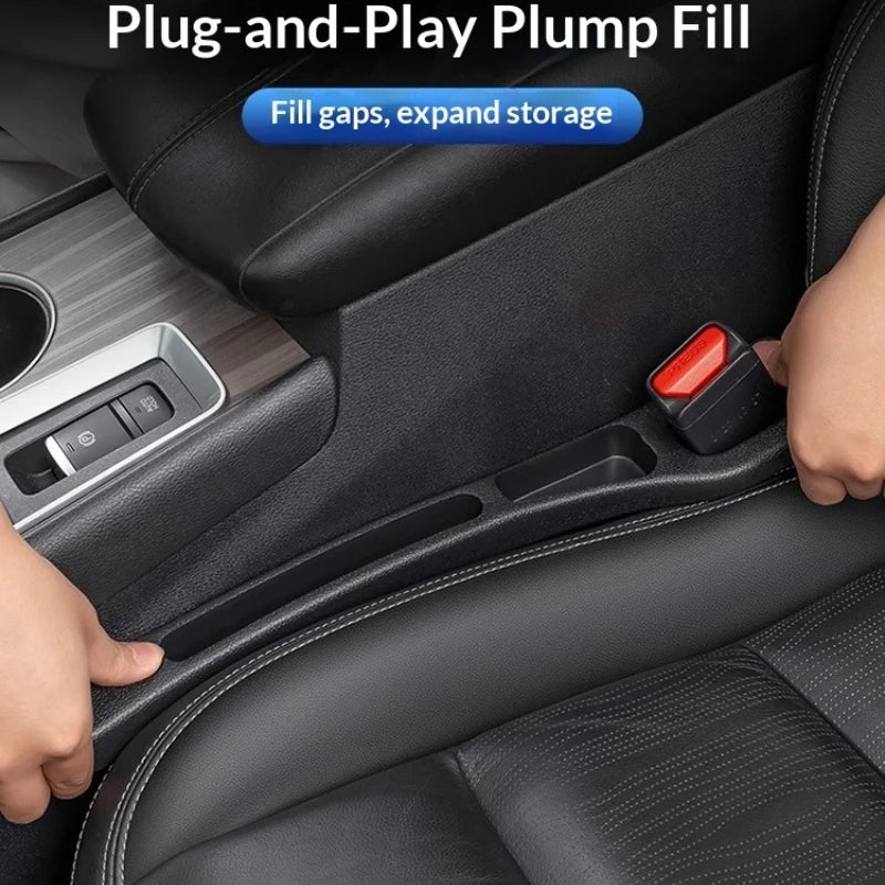 A hand is inserting a red plug-and-play filler strip into a gap in a black car seat to expand storage.