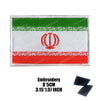 An embroidered flag patch featuring horizontal stripes of green, white, and red with a central red emblem.