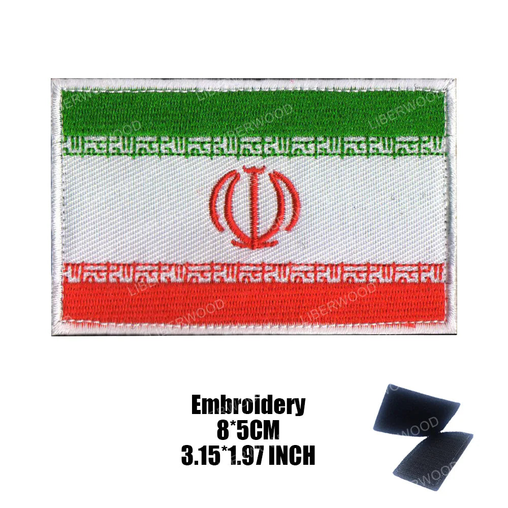 An embroidered flag patch featuring horizontal stripes of green, white, and red with a central red emblem.