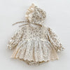 A light floral lace cotton romper for a baby girl with ruffled sleeves and a gathered neckline.