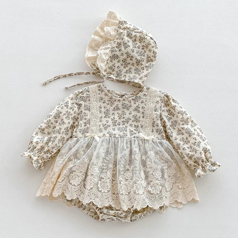 A light floral lace cotton romper for a baby girl with ruffled sleeves and a gathered neckline.