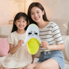 A young woman and a girl are holding an interactive musical plush banana toy with a touch sensor.
