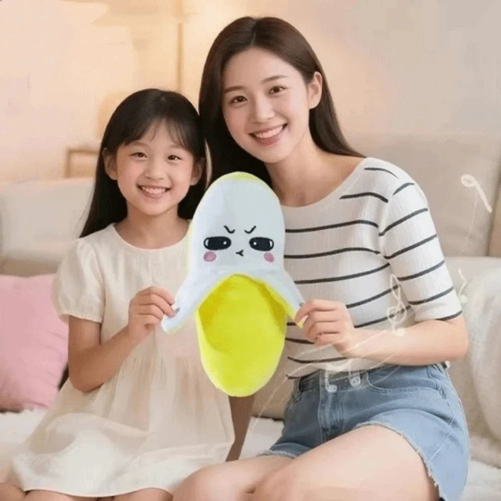 A young woman and a girl are holding an interactive musical plush banana toy with a touch sensor.