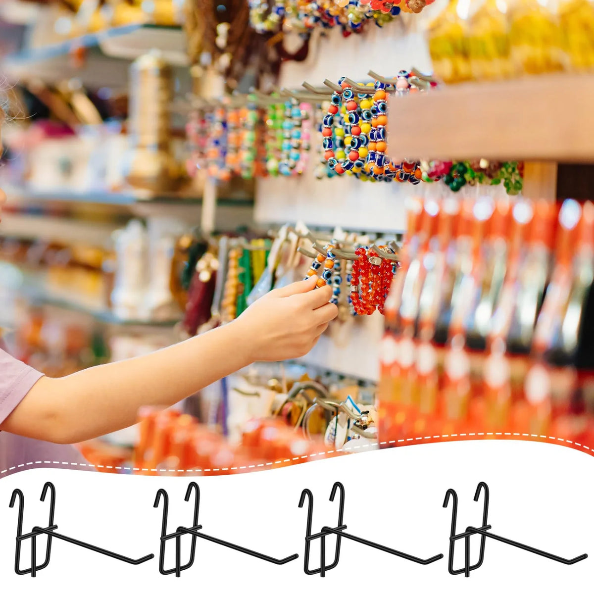 A hand is placing heavy duty grid hooks onto a display rack of colorful beaded items.