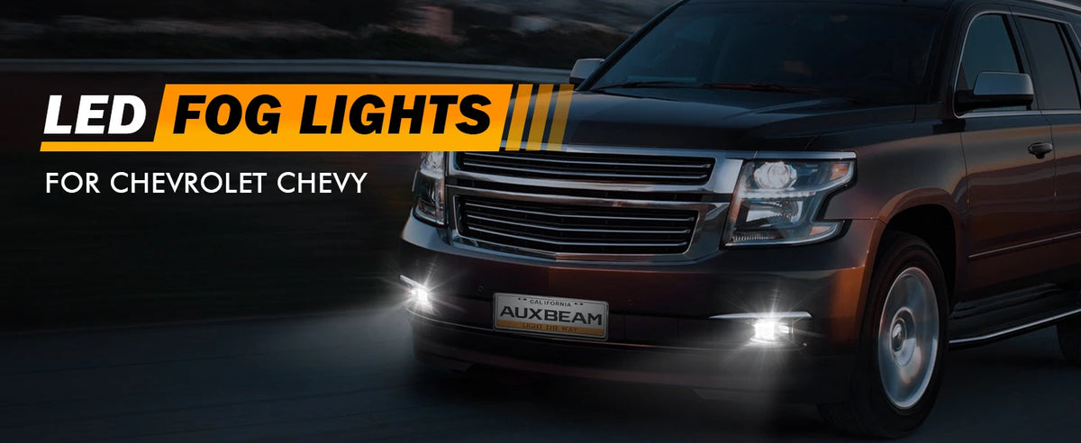 Close-up of an LED fog light assembly installed on a dark colored Chevrolet truck.