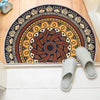 A tribal boho semi-circle doormat with earthy tones and intricate patterns is displayed on a white floor.