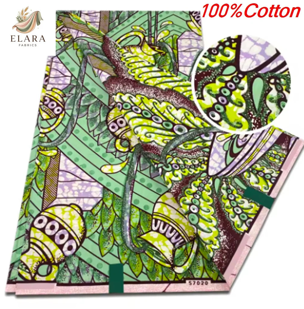 A fabric print featuring green and pink African wax design on a light background.