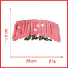Pink embroidered patch with the text God Is Good all the time on a white background.