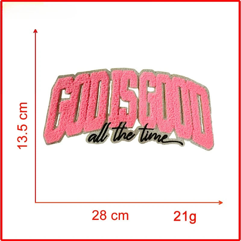 Pink embroidered patch with the text God Is Good all the time on a white background.