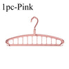 A single pink foldable multi-hole space-saving clothes hanger.