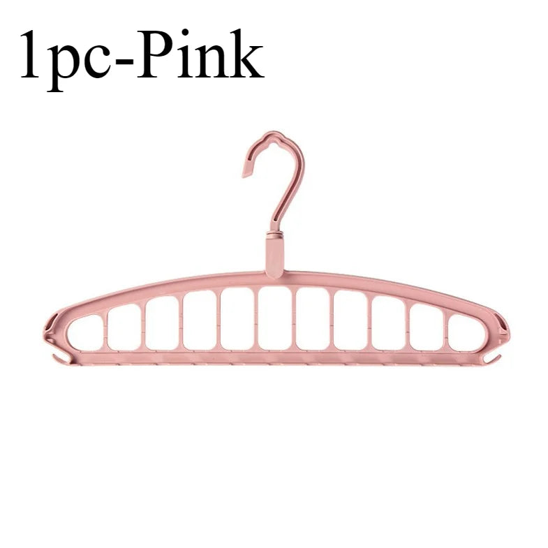 A single pink foldable multi-hole space-saving clothes hanger.