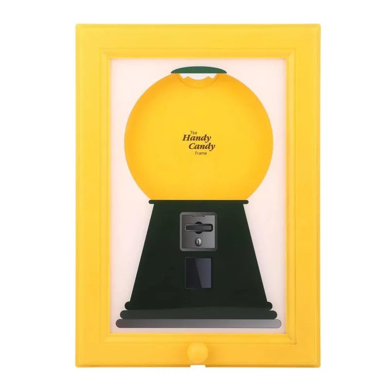 A vintage yellow frame displaying a black rotating candy display frame with a green dust cover.