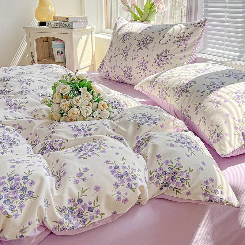 Lavender floral duvet cover set featuring purple and green floral patterns on a light pink background.
