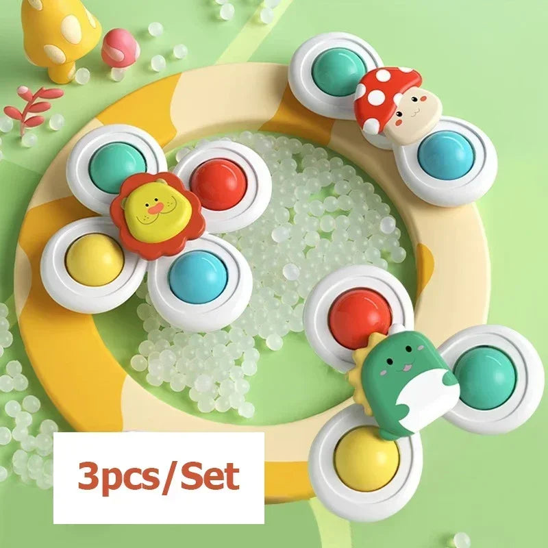 A set of three colorful spinning bath toys with various shapes and colors for toddlers