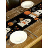 Black Halloween table runner featuring pumpkins, bats, and jack-o'-lanterns designs.