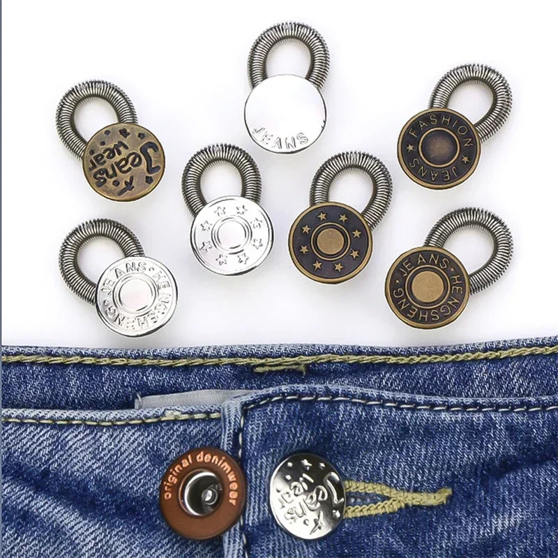 A collection of adjustable metal extender buttons for jeans and trousers displayed on a denim fabric.