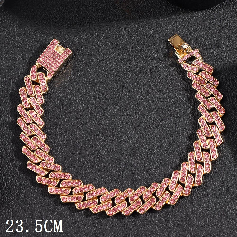 Gold-toned Cuban link anklet with pink cubic zirconia stones on a black background