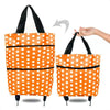 Orange polka dot foldable rolling shopping bag with black handles and wheels