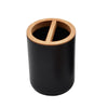 A black cylindrical bathroom organizer made of bamboo with a slotted dispenser.