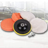 A set of six car polishing pads in orange and white with a drill adapter shown on a white towel.