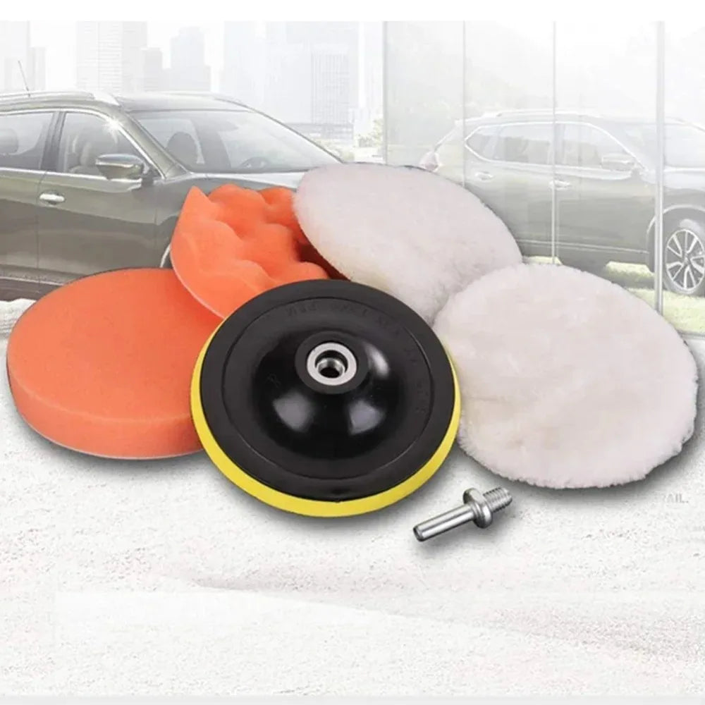 A set of six car polishing pads in orange and white with a drill adapter shown on a white towel.