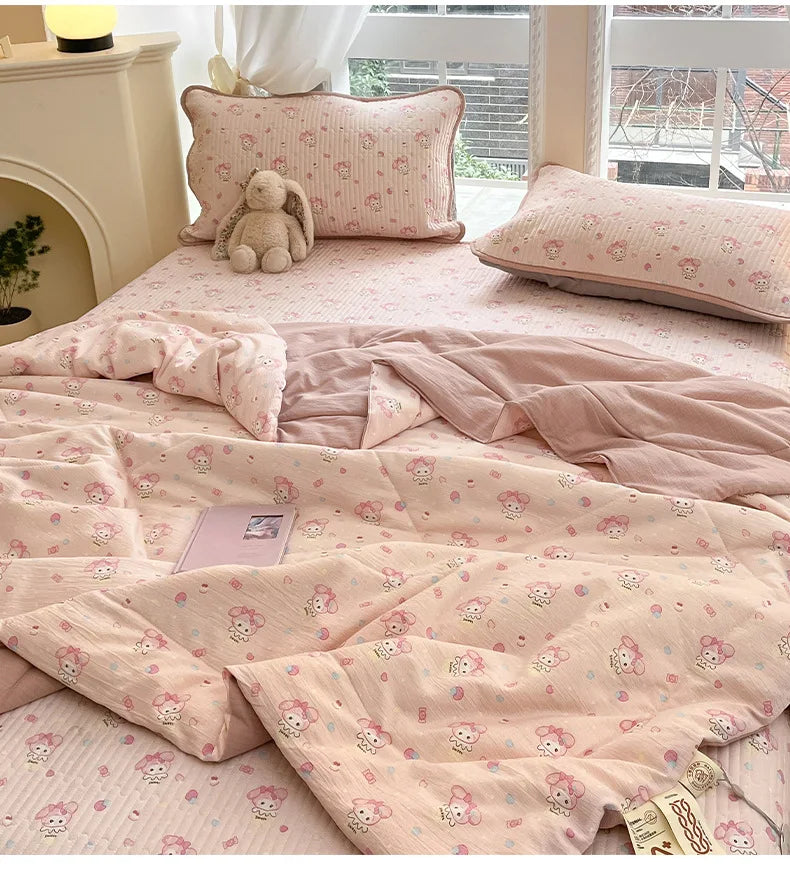 Pink cartoon pattern kids lightweight summer quilt spread on a bed