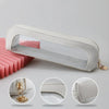 A clear waterproof travel makeup organizer pouch with a white leather trim shown from the side and close-up views.