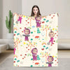 A beige flannel throw blanket featuring a colorful cartoon design of Masha and Bear characters.