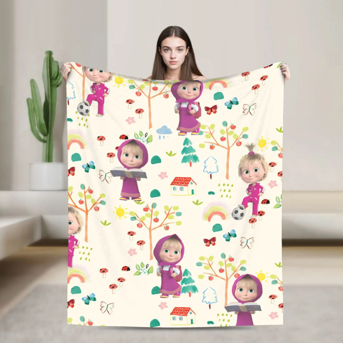 A beige flannel throw blanket featuring a colorful cartoon design of Masha and Bear characters.
