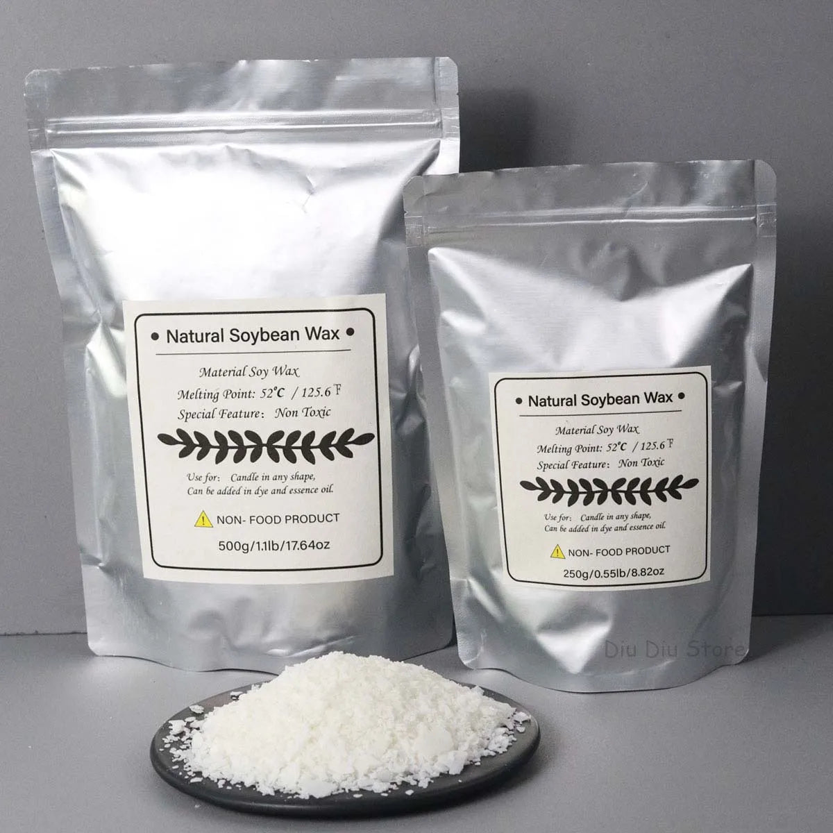 Two bags of natural soy wax flakes are shown next to a pile of white soy wax on a dark plate.