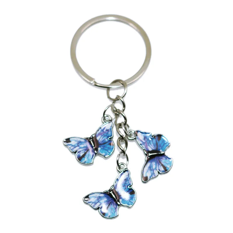 Silver butterfly keychain charm with blue and purple iridescent wings